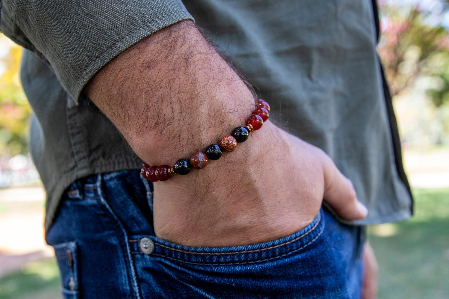 Man hand with gemstone beaded healing bracelet for energy and vitality